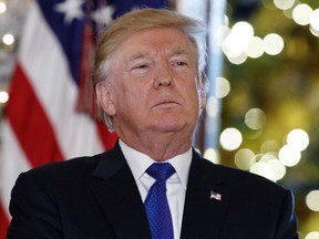 President Donald Trump listens people speak in support of Republican tax policy reform, during an event in the Grand Foyer of the White House, Wednesday, Dec. 13, 2017, in Washington. Americans are painting a pessimistic view of the country and President Donald Trump as 2017 comes to a close. That's according to a new poll from The Associated Press-NORC Center for Public Affairs Research. The survey shows less than a quarter of Americans think Trump has made good on the pledges he made to voters while running for president.