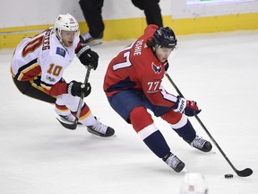 In this Nov. 20, 2017 photo, Washington Capitals right wing T.J. Oshie (77) skates with the puck past Calgary Flames right wing Kris Versteeg (10) during the third period of an NHL hockey game in Washington. Oshie is expected to return to the Washington Capitals' lineup Tuesday at the Dallas Stars after missing six games with a concussion.