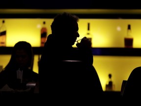 In this Nov. 30, 2017, photo, Dennis Dubrow, 62, Oceanport, N.J., takes a sip of his drink while having a meal at the William Hill Sports Bar in West Long Branch, N.J. The bar is located inside the Monmouth Park racetrack building. With banks of TVs tuned to all-sports stations and a spacious bar, the lounge is a sports gamblers' paradise-in-waiting. All that's standing in its way: A 25-year-old federal law that bars betting on sports in most states. The high court is weighing On Dec. 4, whether a federal law that prevents states from authorizing sports betting is constitutional. If the Supreme Court strikes down the law, giving sports betting the go-ahead, dozens of states could quickly make sports betting legal.
