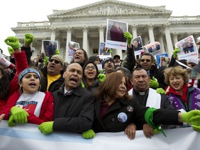 In this De. 6, 2017 photo, Rep. Luis Gutierrez D-Ill., third from left, along with other demonstrators protest outside of the U.S. Capitol in support of the Deferred Action for Childhood Arrivals (DACA), and Temporary Protected Status (TPS), programs, during an rally on Capitol Hill in Washington.  House and Senate Democrats stand divided over whether to fight now or later about the fate of some 800,000 young immigrants who came to the U.S. illegally as children.