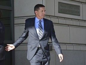 FILE - In this Dec. 1, 2017 file photo, former Trump national security adviser Michael Flynn leaves federal court in Washington.  People close to Flynn are telling The Associated Press about the emotional pressures he faced in the past year as special counsel Robert Mueller closed in on him and also investigated his son.