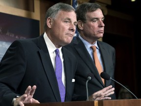 In this Oct. 4, 2017 file photo, Senate Select Committee on Intelligence Chairman Richard Burr, R-N.C., left, and Vice Chairman Mark Warner, D-Va., update reporters on the status of their inquiry into Russian interference in the 2016 U.S. elections, at the Capitol in Washington.