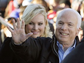 FILE - In this Oct. 30, 20087 file photo, Republican presidential candidate Sen. John McCain, R-Ariz., accompanied by his daughter Meghan McCain, waves to supporters as he enters a campaign rally in Defiance, Ohio.  Former Vice President Joe Biden sought to console the daughter of ailing Sen. John McCain after she began crying while discussing her father's cancer on ABC's "The View." McCain is battling the same aggressive type of brain cancer that killed Biden's son Beau in 2015.