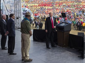FILE - In this July 24, 2017, file photo, President Donald Trump turns and looks at, from left, Secretary of Health and Human Services Tom Price, Secretary of Energy Rick Perry, and Interior Secretary Ryan Zinke as he speaks at the 2017 National Scout Jamboree in Glen Jean, W.Va. For an administration that has spent 2017 throwing off headlines at a stunningly dizzying pace, the frenetic fortnight in the second half of July reached an unparalleled breakneck speed. Set amid the backdrop of a president grappling with his deepest insecurities, the West Wing's breakdown in policy collided with its collapse in personnel and acted as a crucial inflection point for Trump's first year in office.