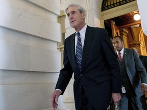 FILE - In this June 21, 2017, file photo, former FBI Director Robert Mueller, the special counsel probing Russian interference in the 2016 election, departs Capitol Hill in Washington. President Donald Trump's transition organization is arguing that a government agency improperly turned over a cache of emails to Mueller as part of his investigation into contacts between Trump associates and Russia. The complaint by the transition team is the latest attempt to undermine Mueller's investigation in the public sphere.
