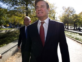 FILE - In this Nov. 2, 2017, file photo, Paul Manafort accompanied by his lawyers, arrives at U.S. Federal Court, in Washington. Prosecutors working for special counsel Robert Mueller say Manafort has been working on an op-ed with a longtime colleague "assessed to have ties" to a Russian intelligence service. Court papers say that Manafort and the colleague sought to publish the op-ed under someone else's name and intended it to influence public opinion about his work in Ukraine.