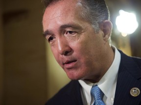 FILE - In this March 24, 2017, file photo, Rep. Trent Franks, R-Ariz. speaks with a reporter on Capitol Hill in Washington. Franks says he is resigning Jan. 31 amid a House Ethics Committee investigation of possible sexual harassment. Franks says in a statement that he never physically intimidated, coerced or attempted to have any sexual contact with any member of his congressional staff. Instead, he says, the dispute resulted from a discussion of surrogacy. Franks and his wife have 3-year-old twins who were conceived through surrogacy.