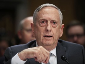 FILE - In this Oct. 30, 2017, file photo, Secretary of Defense Jim Mattis testifies on Capitol Hill in Washington. Mattis is warning against dangerous flights by Russian fighter jets over what is considered a safe zone in Syria, questioning whether recent incidents were mistakes or deliberately unwise maneuvers. Mattis tells Pentagon reporters that the U.S. and Russia are still using a phone line to deconflict flights over the crowded Syrian skies as the U.S.-led coalition goes after remaining Islamic State militants.