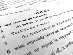 In this Dec. 4, 2017, photo, part of the Republican Senate bill "Tax Cuts and Jobs Act" is photographed in Washington. Republican tax legislation advancing toward final votes in Congress could undermine "Obamacare" health insurance markets, and add to the financial squeeze on Medicare over time. This week lawmakers will try to resolve differences between House and Senate versions in hopes of finishing around Christmas. Also in play are the tax deduction for people with high medical expenses, and a tax credit for drug makers that develop treatments for diseases affecting relatively few patients.