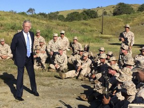 FILE - In this Dec. 21. 2017, file photo, Defense Secretary Jim Mattis talks to U.S. Marine Corps troops at a rifle range at Guantanamo Bay, Cuba. For only the second time since 9/11, America's defense secretary didn't visit U.S. troops in a war zone during December, breaking a longstanding tradition of personally and publicly thanking service members in combat who are separated from their families during the holiday season.