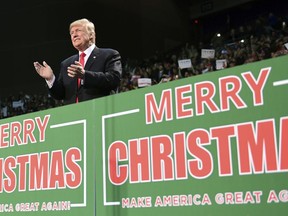 FILE - In this Dec. 8, 2017, file photo, President Donald Trump takes to the stage at a campaign-style rally at the Pensacola Bay Center, in Pensacola, Fla. There's no mistaking Trump's "Merry Christmas" message _ he wields it as a weapon against political correctness. For weeks, he's been liberally sprinkling his public remarks with Christmas tidings.