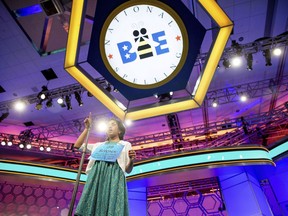 FILE - In this May 28, 2015, file photo, Siyona Mishra, 11, of Orlando, Fla. gestures while trying to spell "hacek" during the finals of the Scripps National Spelling Bee at National Harbor in Oxon Hill, Md. The Scripps National Spelling Bee has announced a rule change that could result in the field of spellers nearly doubling, from fewer than 300 to more than 500. Previously, spellers had to win their regional bee to make it to nationals. For three years running, Siyona Mishra and Dhyana Mishra faced off amid some of the highest stakes in competitive spelling. They outlasted the rest of the field at the regional spelling bee in Orlando in 2015, 2016 and this year. But there was only room at the Scripps National Spelling Bee for one of them. Siyona finished eighth overall at nationals in 2015, but last year, she lost the regional bee to Dhyana _ the two are not related _ and had no way to return.
