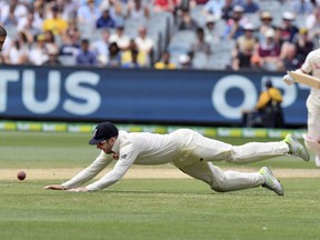 England's Mark Stoneman dives to field against Australia during the fifth day of their Ashes cricket test match in Melbourne, Australia, Saturday, Dec. 30, 2017.