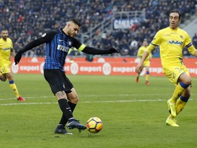Inter Milan's Mauro Icardi, left, scores a goal during the Serie A soccer match between Inter Milan and Chievo Verona at the San Siro stadium in Milan, Italy, Sunday, Dec. 3, 2017.