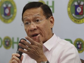 Philippine Health Secretary Francisco Duque III gestures as he answers questions from reporters in Manila, Philippines,  Friday, Dec. 1, 2017. The Philippines has put on hold its dengue immunization program after new findings by vaccine manufacturer Sanofi Pasteur that severe cases of dengue can occur among those vaccinated without prior dengue infection. (AP Photo/Aaron Favila)