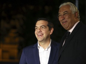 Greece Prime Minister Alexis Tsipras, left, is welcomed by his Portuguese counterpart Antonio Costa at the Sao Bento palace in Lisbon, Friday, Dec. 1, 2017.