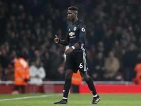Manchester United's Paul Pogba leaves the pitch after being shown a red card during the English Premier League soccer match between Arsenal and Manchester United at the Emirates stadium in London, Saturday, Dec. 2, 2017.