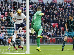 Tottenham Hotspur's Harry Kane, heads the ball to score the opening goal of the game during their English Premier League soccer match between Tottenham Hotspur and Southampton at Wembley stadium in London, Tuesday, Dec 26 2017.