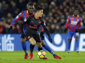 Arsenal's Alexis Sanchez, front, shields the ball from Crystal Palace's Christian Benteke during their English Premier League soccer match between Crystal Palace and Arsenal at Selhurst Park stadium in London, Thursday, Dec. 28, 2017.