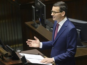 Poland's new Prime Minister Mateusz Morawiecki gives his policy speech in the parliament in Warsaw, Poland, Tuesday, Dec. 12, 2017. Morawiecki outlined his foreign and home policy goals, a day after he was sworn in and tasked with boosting the economy and Poland's image abroad.