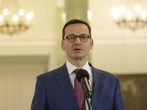 Mateusz Morawiecki speaks to the press after being designated for the post of Poland's Prime Minister in Warsaw, Poland, Friday, Dec. 8, 2017.
