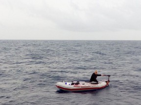 In this photo taken on Dec. 1, and made available on Dec. 4, 2017, a Syrian refugee is spotted in his 3-meter (10-foot) long rubber boat some 25 miles off Libya's coast by the NGO rescue boat of Proactiva Open Arms. The man, 30, who had set out solo in his tiny rubber boat trying to reach the Lampedusa Island, was rescued by the NGO boat. According to rescuers he was suffering from shock. (Proactiva Open Arms/via AP Photo)