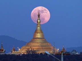 The moon rises behind the Uppatasanti Pagoda seen in Naypyitaw, Myanmar, Sunday, Dec. 3, 2017. The Dec. 3 full moon is the first of three consecutive supermoons. The two will occur on Jan. 1 and Jan. 31, 2018.