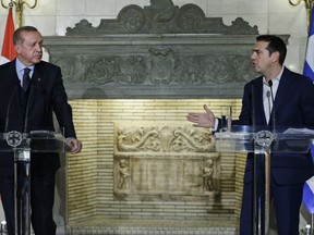 Greece's Prime Minister Alexis Tsipras, right, talks during a joint news conference with Turkey's President Recep Tayyip Erdogan, left, at Maximos Mansion in Athens,Thursday, Dec. 7, 2017. Erdogan's visit to Greece comes as his country finds itself increasingly isolated on the international stage, and his comments will be closely watched for signs he might try to improve some of Turkey's international relations, particularly with the European Union.