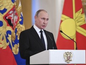 Russian President Vladimir Putin delivers a speech during an award ceremony in the Kremlin, in Moscow, Russia, Thursday, Dec. 28, 2017, for Russian Armed Forces service personnel who took part in the anti-terrorist operation in Syria. Putin said at Thursday's award ceremony that Wednesday's explosion at a supermarket in the country's second-largest city was a terrorist attack.