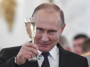 Russian President Vladimir Putin makes a toast during an award ceremony in the Kremlin, in Moscow, Russia, Thursday, Dec. 28, 2017, for Russian Armed Forces service personnel who took part in the anti-terrorist operation in Syria. Putin said at Thursday's award ceremony that Wednesday's explosion at a supermarket in the country's second-largest city was a terrorist attack.