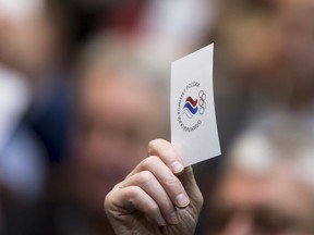 Russian athletes vote with their ballots during an Russian Olympic committee meeting in Moscow, Russia, Tuesday, Dec. 12, 2017. Russia's Olympic Committee said on Tuesday that Russian athletes are overwhelmingly in favor of competing at the 2018 Winter Games despite a ban on the national team.