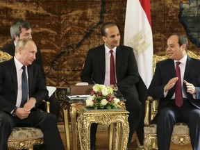 Russian President Vladimir Putin, left, listens to Egyptian President Abdel-Fattah El-Sissi, during their meeting in Cairo, Egypt, Monday, Dec. 11, 2017.