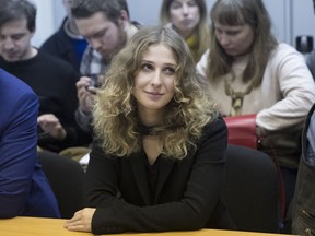 Russian activist of the feminist protest group Pussy Riot Maria Alekhina listens in a court room in Moscow, Thursday, Dec. 21, 2017.  Alekhina, member of the punk band Pussy Riot, was detained on Wednesday for a protest outside the headquarters of Russia's main security agency and was sentenced on Thursday to 40 hours of community work.