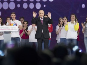 Russian President Vladimir Putin gestures as he speaks at the annual Volunteer of Russia 2017 award ceremony at the Megasport Sport Palace in Moscow, Russia, Wednesday, Dec. 6, 2017. Putin has moved an inch closer to announcing his intention to seek re-election in the next March's vote, saying he would weigh the move based on public support.