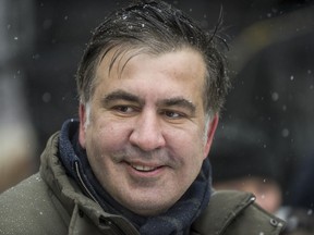 FILE - In this file photo taken Wednesday, Dec. 6, 2017, former Georgian president Mikheil Saakashvili smiles surrounded by his supporters as they camp outside parliament demanding the resignation of the Ukrainian president, in Kiev, Ukraine.  Ukraine's prosecutor-general Yuriy Lutzenko has announced Friday Dec. 8, 2017, that opposition figure Mikheil Saakashvili has been arrested.