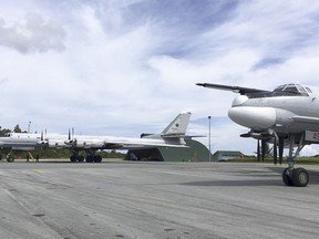 In this photo released by Russian Defense Ministry official web site Tuesday, Dec. 5, 2017 shows Russian Tu-95 bombers arrive on Biak Island in Indonesia. The visit by the bombers capable of carrying nuclear weapons seems to underline Russia's resurgent military might and its desire to expand its foothold around the world.(AP Photo/ Russian Defense Ministry Press Service)