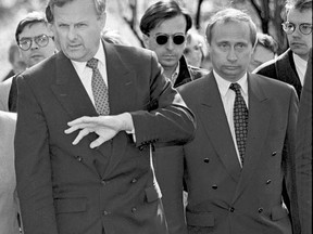 FILE In this file photo taken in 1994, Anatoly Sobchak, then the city mayor, St.Petersburg, left, gestures as Vladimir Putin, right, then St.Petersburg deputy mayor, stands next to him, during a city event in St. Petersburg, Russia. After 18 years as Russia's leader _ and with another six-year term sure to follow a March election _ Putin doesn't show the appetites or vulnerabilities that can personalize Western politics, even when staged or spun. If he has moments of merriment or melancholy, they happen in private.