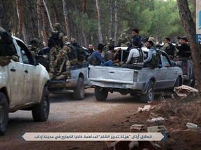 FILE - This Sunday, July 9, 2017 file photo, released by Ibaa news agency, the communications arm of the al Qaeda-linked Levant Liberation Committee, that is consistent with independent AP reporting, shows al-Qaida-linked fighters gathering ahead of raids in the northwestern Syrian city of Idlib in search for members of the Islamic State group. As President Bashar Assad seeks to reassert his authority in the northern province of Idlib he may be aided by deep fractures within the militant extremist group that that dominates in the region.