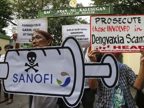 Protesters display placards during a rally outside the Department of Health as they demand accountability for government officials involved in the controversial immunization of the anti-dengue vaccine Dengvaxia to more than 700,000 Filipino children Friday, Dec. 8, 2017 in Manila, Philippines. The controversial vaccine, manufactured by Sanofi Pasteur, was put on hold by the Philippines last week after new study findings showed it posed risks of severe cases in people without previous infection. The controversy has prompted the Philippine Senate to conduct an investigation.