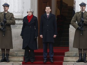 British Prime Minister Theresa May, left, is welcomed to Poland by Polish Prime Minister Mateusz Morawiecki in Warsaw, Poland, Thursday Dec. 21, 2017. May's visit to the Polish capital comes as a politically turbulent time for both countries, as Britain prepares to leave the European Union and Poland finds itself in a escalating standoff with the bloc over a bitterly criticized overhaul of its judicial system.