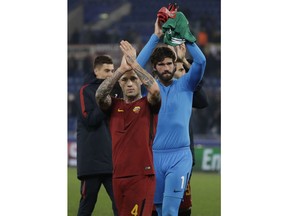 Roma goalkeeper Alisson, right and Roma's Radja Nainggolan celebrate their victory at the end of the group C Champions League soccer match between Roma and Qarabag at the Stadio Olimpico in Rome, Italy, Tuesday, Dec. 5, 2017.