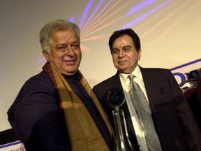FILE- In this June 2, 2005 file photo, legendary Bollywood actor Dilip Kumar, right, looks at veteran actor Shashi Kapoor, left, at the inauguration of a new cinema in Mumbai, India. Kapoor was felicitated at the event. Kapoor, a prolific Bollywood actor and producer from the 1970s and '80s, died Monday, Dec. 4, 2017 after a long illness. He was 79.