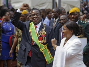 FILE -- In this Friday Nov. 24, 2017 file photo Zimbabwe's President Emmerson Mnangagwa, center, and his wife Auxillia, right, leave after the presidential inauguration ceremony in the capital Harare, Zimbabwe. Zimbabwe's new president is taking steps to differentiate himself from his ousted mentor, Robert Mugabe, as he tries to win over the country before next year's elections.
