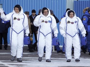 Russian cosmonaut Anton Shkaplerov, center, U.S. astronaut Scott Tingle, right, and Japanese astronaut Norishige Kanai, members of the main crew of the expedition to the International Space Station (ISS), walk to report to members of the State Committee prior the launch of Soyuz MS-07 space ship at the Russian leased Baikonur cosmodrome, Kazakhstan, Sunday, Dec. 17, 2017.