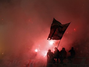 Red Star soccer fans light torches during a Serbian National soccer league derby match between Partizan and Red Star in Belgrade, Serbia, Wednesday, Dec. 13, 2017.