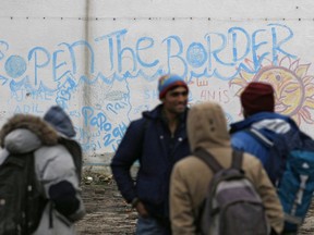 Migrants wait for food in an abandoned factory in the western Serbian town of Sid, near Serbia's border with European Union member Croatia, Monday, Dec. 18, 2017. Several hundred migrants are camping along Serbia's borders, exposed to harsh winter weather and sleeping rough in make-shift shelters as they push on with their desperate bid to reach Western Europe.