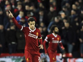 Liverpool's Philippe Coutinho, left, celebrates after scoring his side's second goal during the Champions League Group E soccer match between Liverpool and Spartak Moscow at Anfield, Liverpool, England, Wednesday, Dec. 6, 2017.