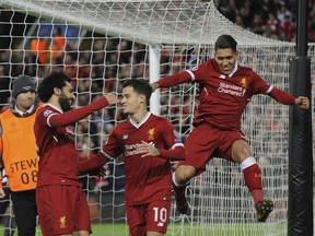 Liverpool's Philippe Coutinho, center, celebrates with his teammates after scoring his side's fifth goal during the Champions League Group E soccer match between Liverpool and Spartak Moscow at Anfield, Liverpool, England, Wednesday, Dec. 6, 2017.
