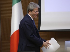 Italian Premier Paolo Gentiloni arrives for the traditional year-end press conference in Rome, Thursday, Dec. 28, 2017.