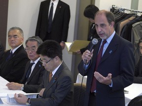 Tomas Quintana, standing, U.N. special rapporteur on the human rights situation in North Korea speaks to the families of Japanese abducted to North Korea during a meeting Friday, Dec. 15, 2017, in Tokyo. Japan has announced it is freezing the assets of 19 companies to step up pressure on North Korea to halt its nuclear weapons and missile development.